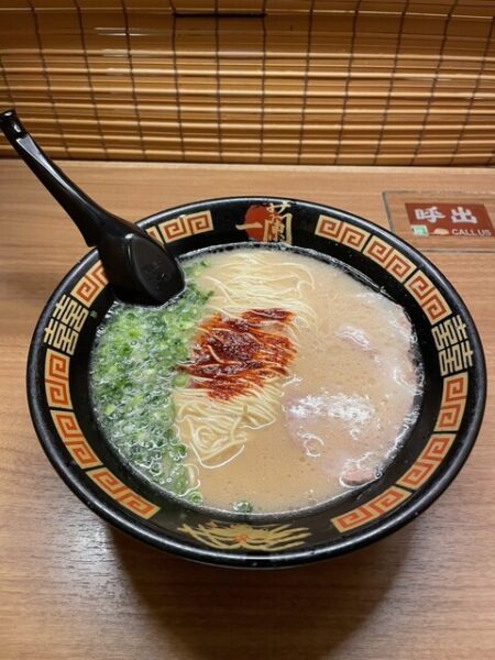 Hakata tonkotsu ramen: creamy pork‑bone broth, ultra‑thin noodles, green onions