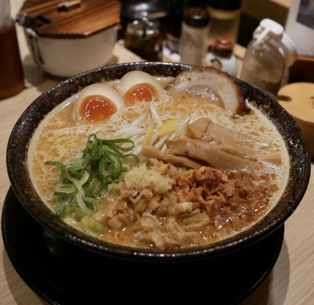 Sapporo miso ramen—rich pork–miso broth with butter, medium‑curly noodles