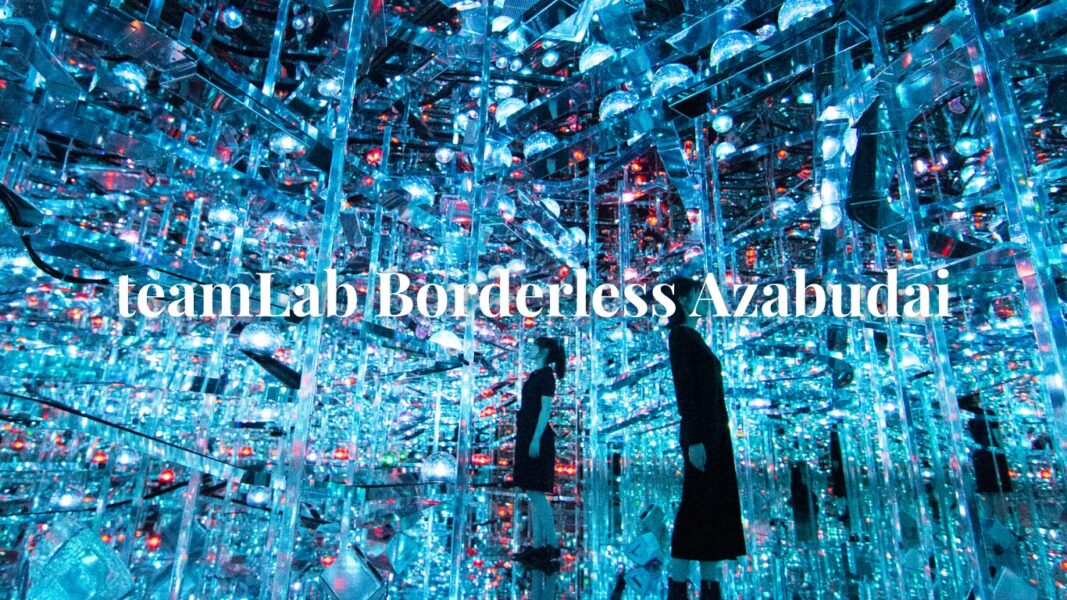 Visitors exploring the illuminated digital art installations at teamLab Borderless Azabudai Hills